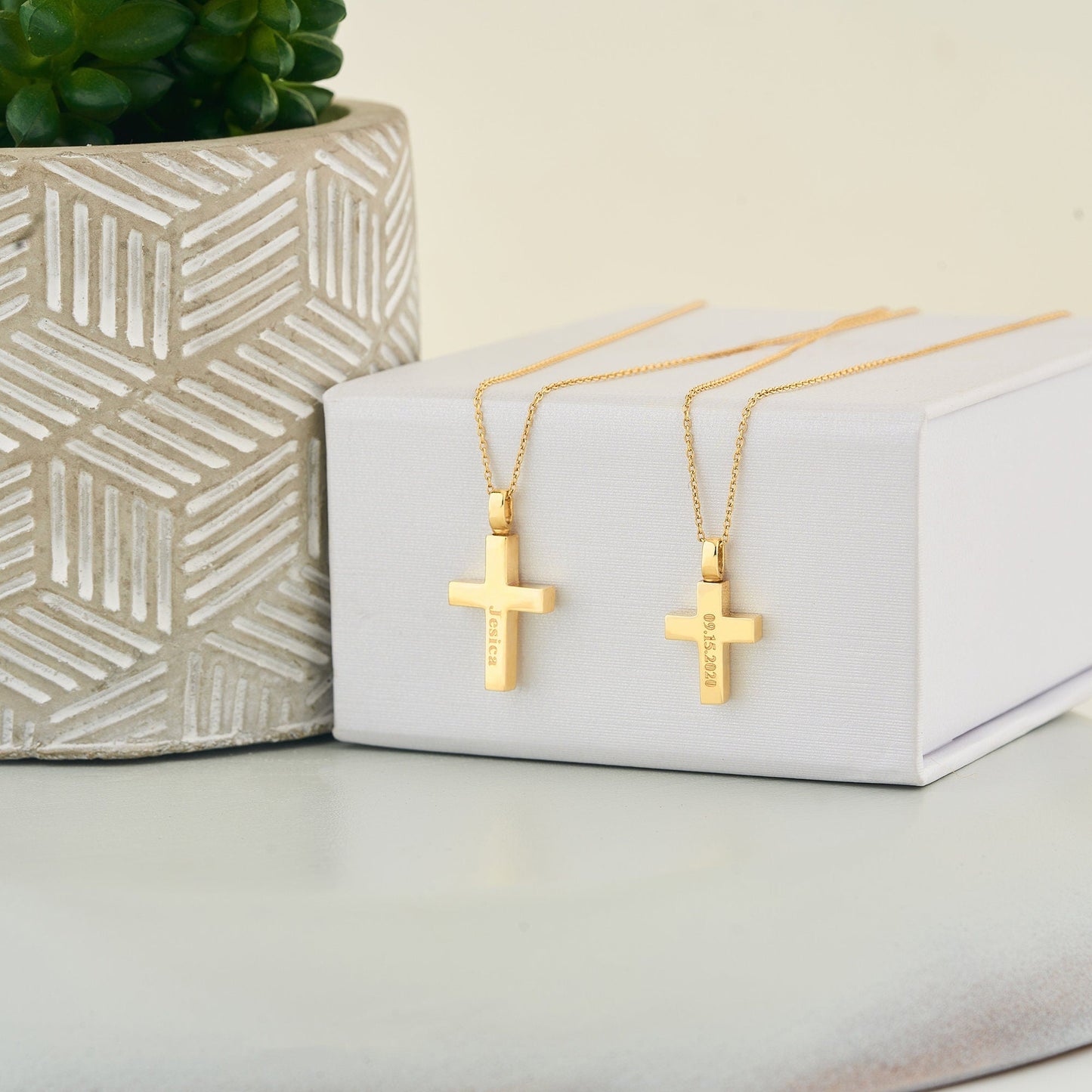 Two gold cross pendant necklaces with delicate chains for a cremation urn necklace