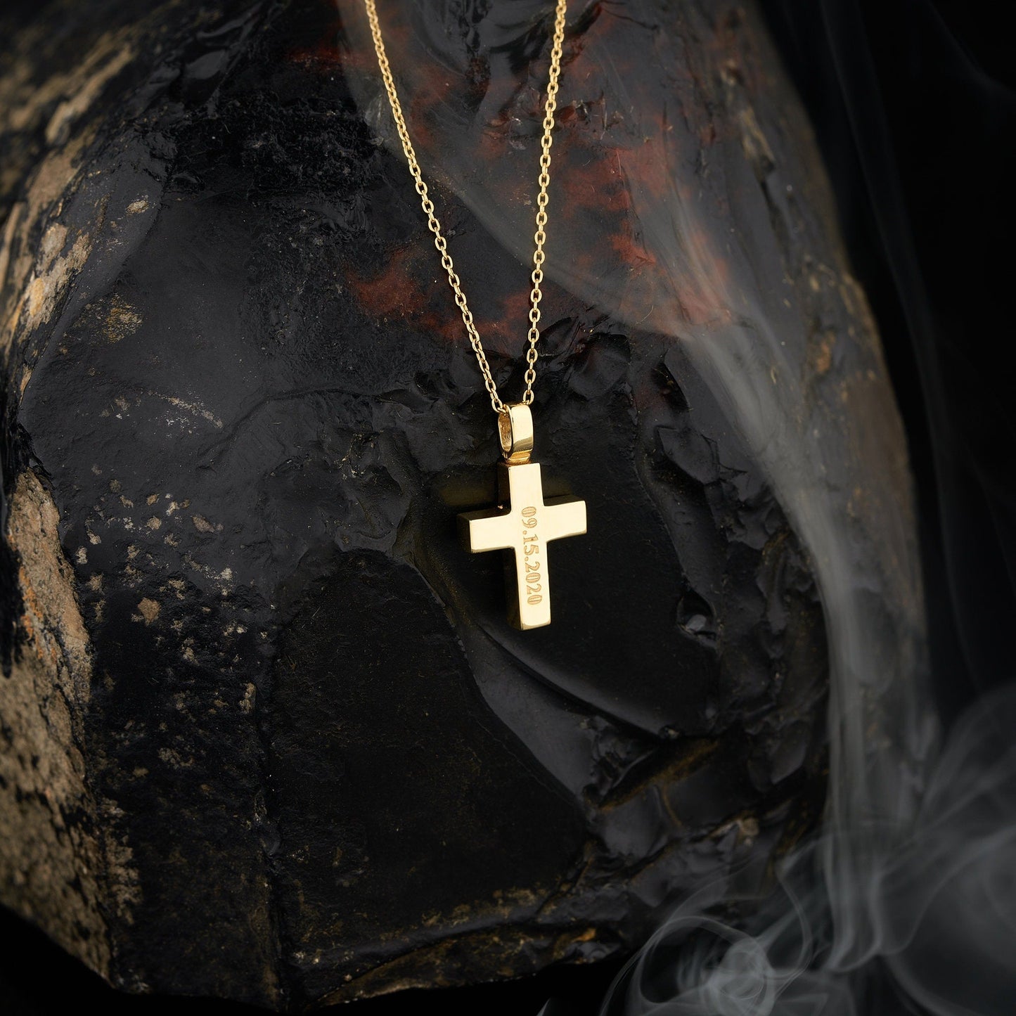 Gold cross pendant on a delicate chain necklace for cremation urn and ashes