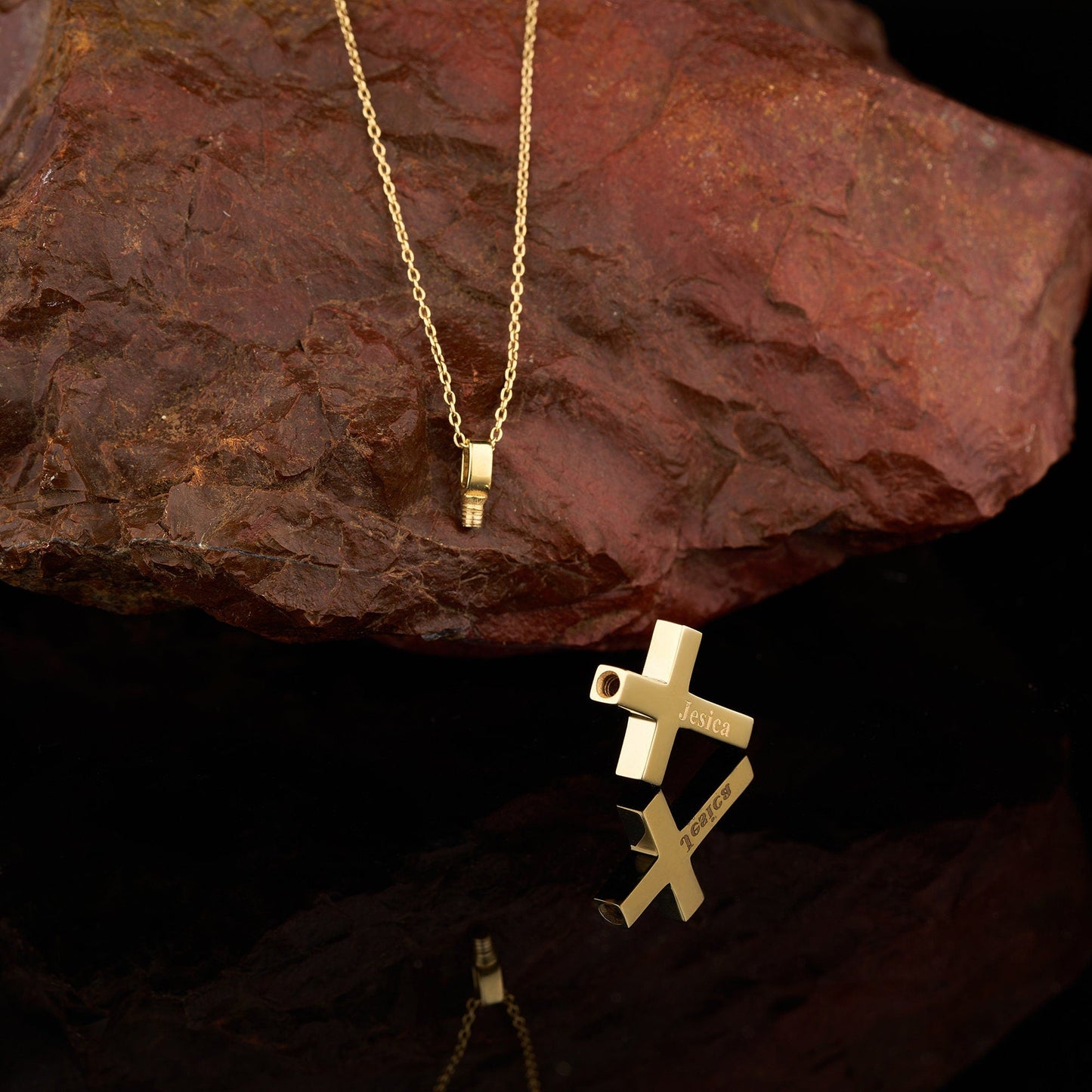 Gold cross pendant on a delicate chain necklace for cremation urn and ashes