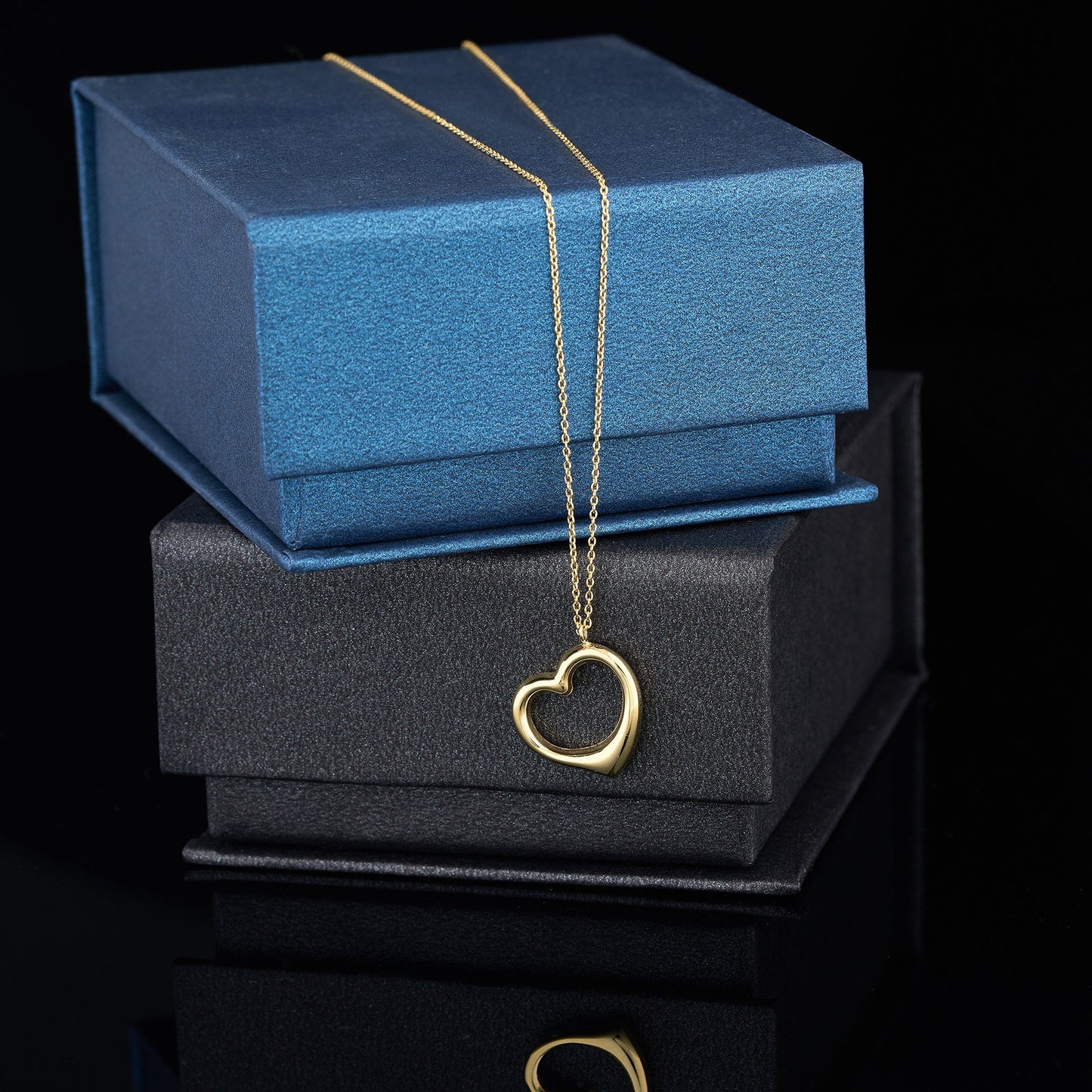 14K Solid Gold Heart Pendant Necklace displayed on elegant jewelry boxes