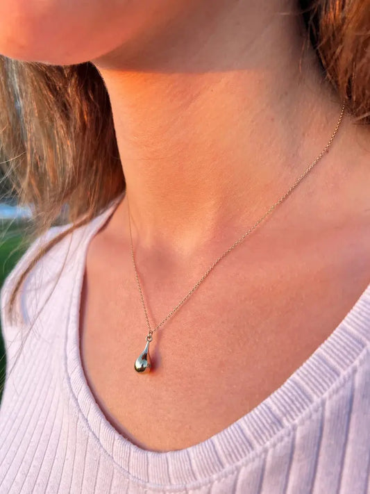 Delicate silver tear drop urn necklace featuring an elegant teardrop pendant