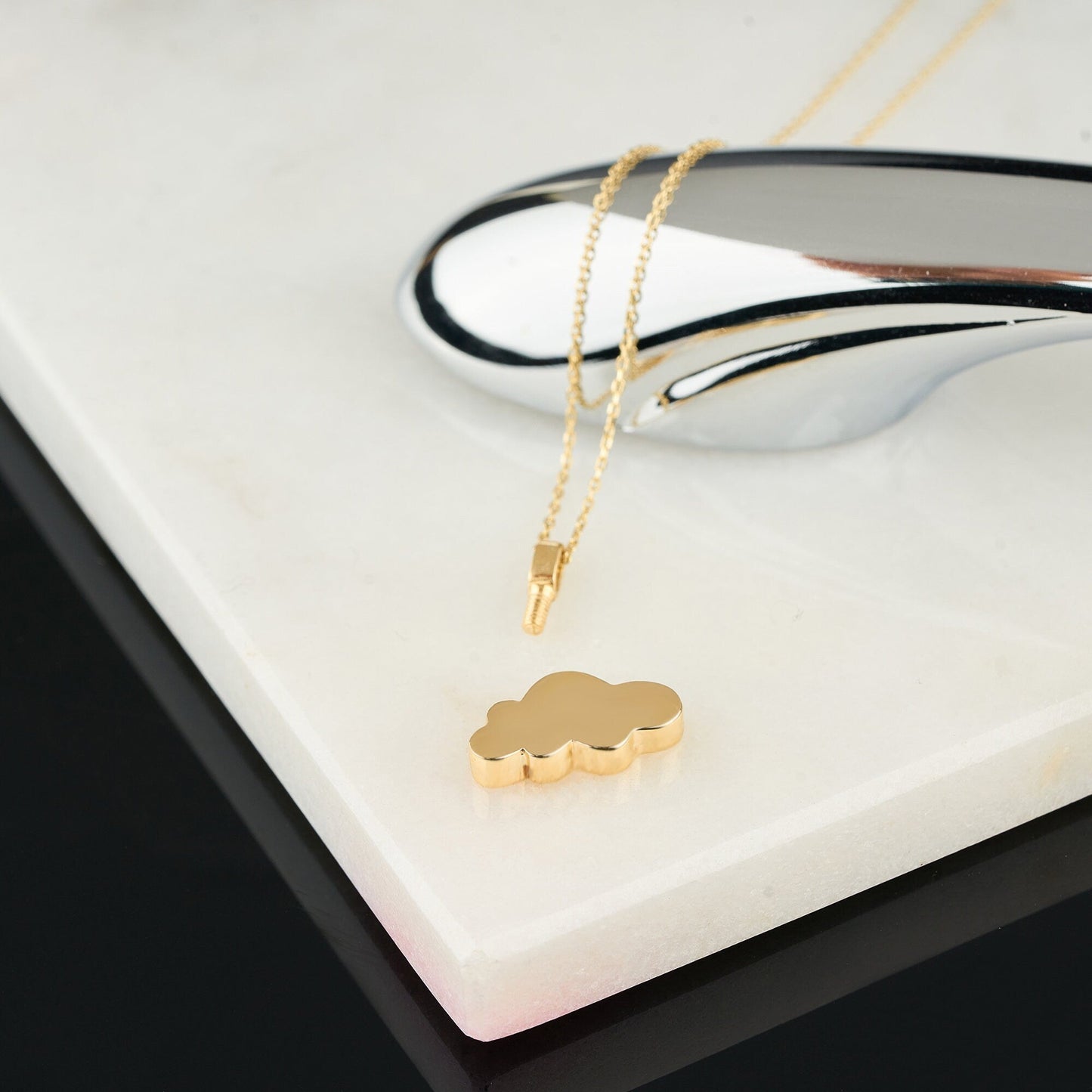 Gold Cloud Urn Necklace featuring a delicate chain and an elegant cloud-shaped pendant