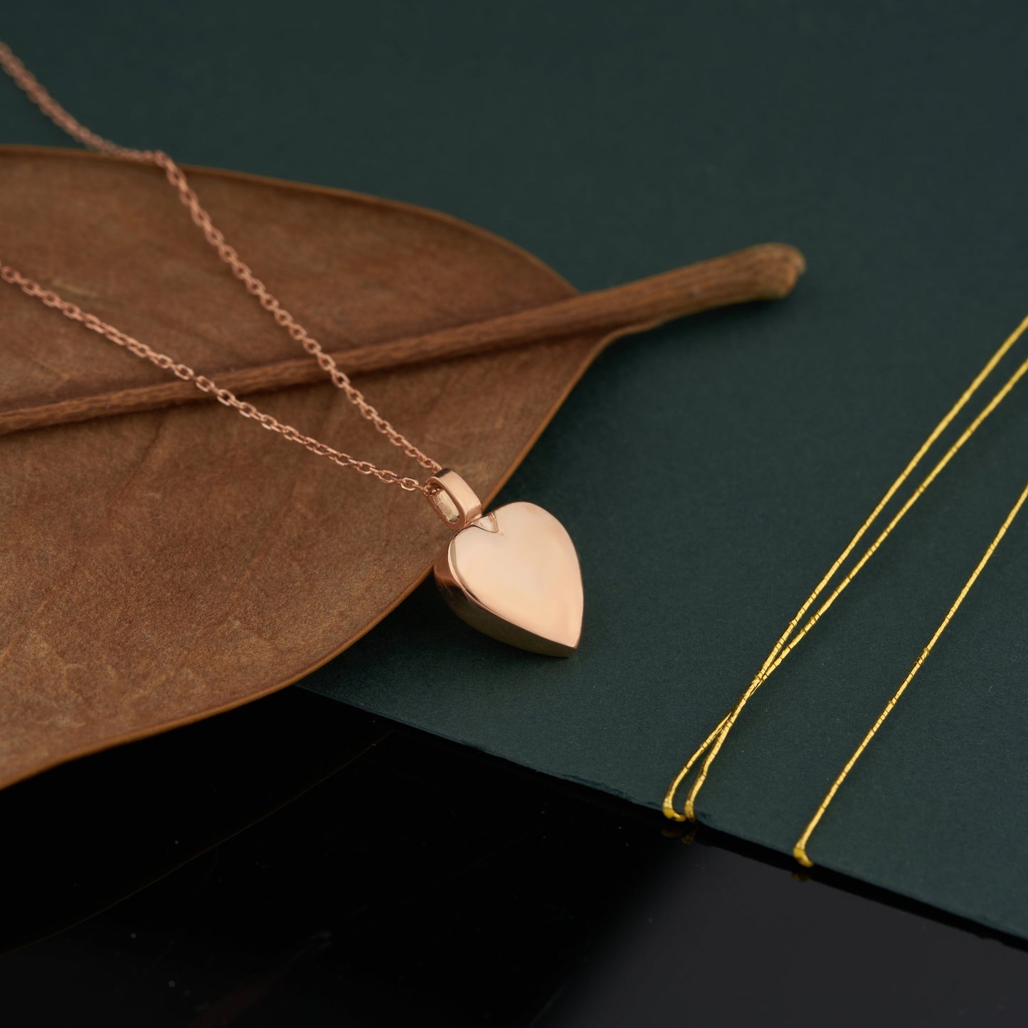 Rose gold heart pendant necklace on a delicate chain in solid gold Mom and Dad heart urn design