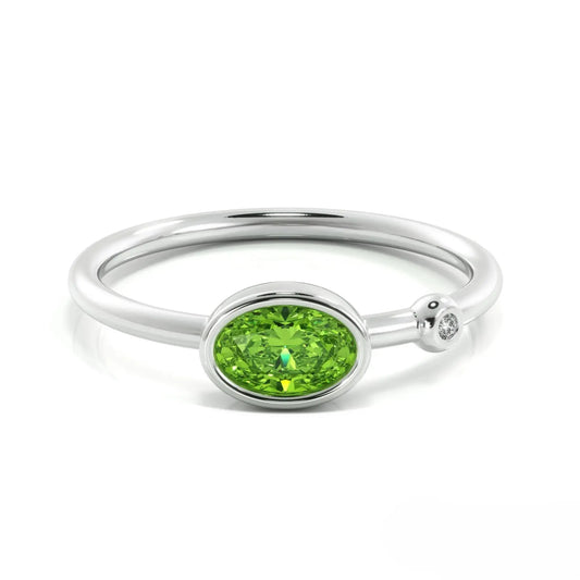 Silver peridot ring featuring an oval peridot gemstone and small diamond accent, August birthstone