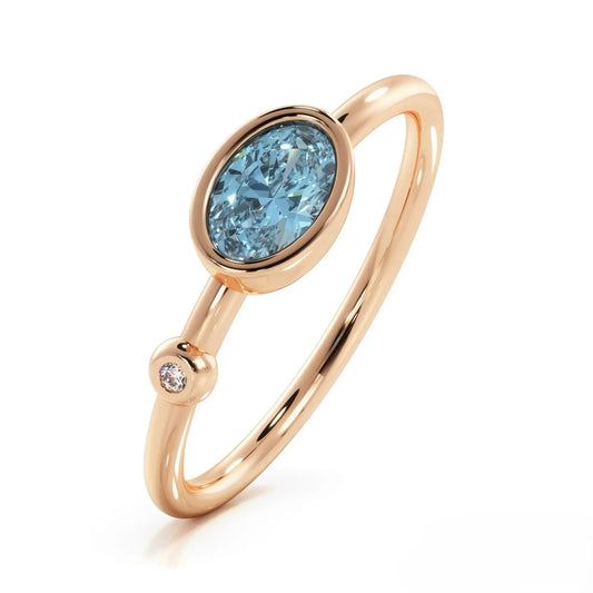 Rose gold ring with oval London Blue Topaz and diamond accent in gemstone ring design