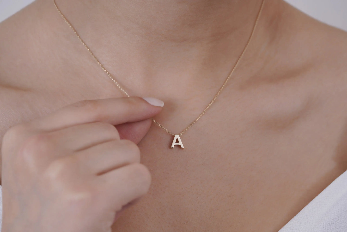 Delicate gold necklace featuring a letter A pendant in 14K solid gold design