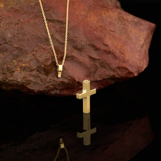 Gold cross pendant on a delicate sterling silver urn necklace with extension chain