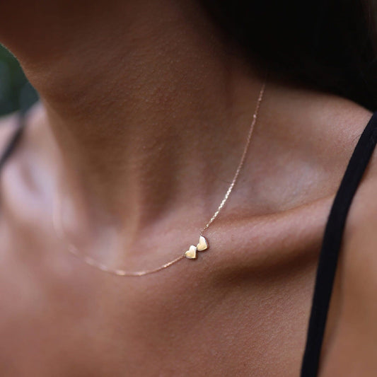 Delicate 14K Double Heart Necklace in solid gold with two tiny heart pendants