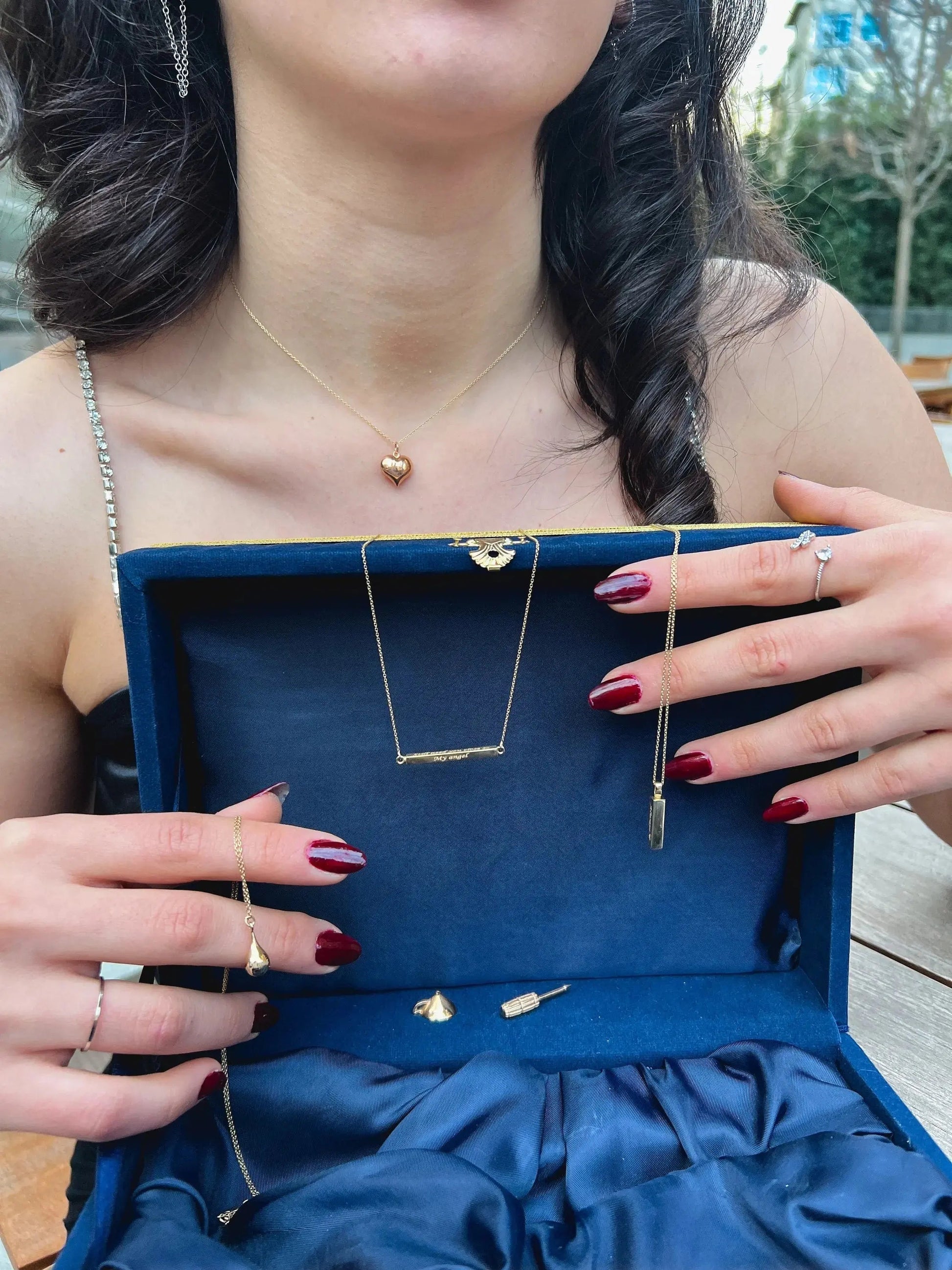 Royal blue velvet jewelry box showcasing personalization cremation urn necklace with gold necklaces