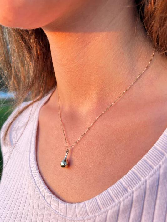 Delicate silver tear drop urn necklace featuring an elegant teardrop pendant