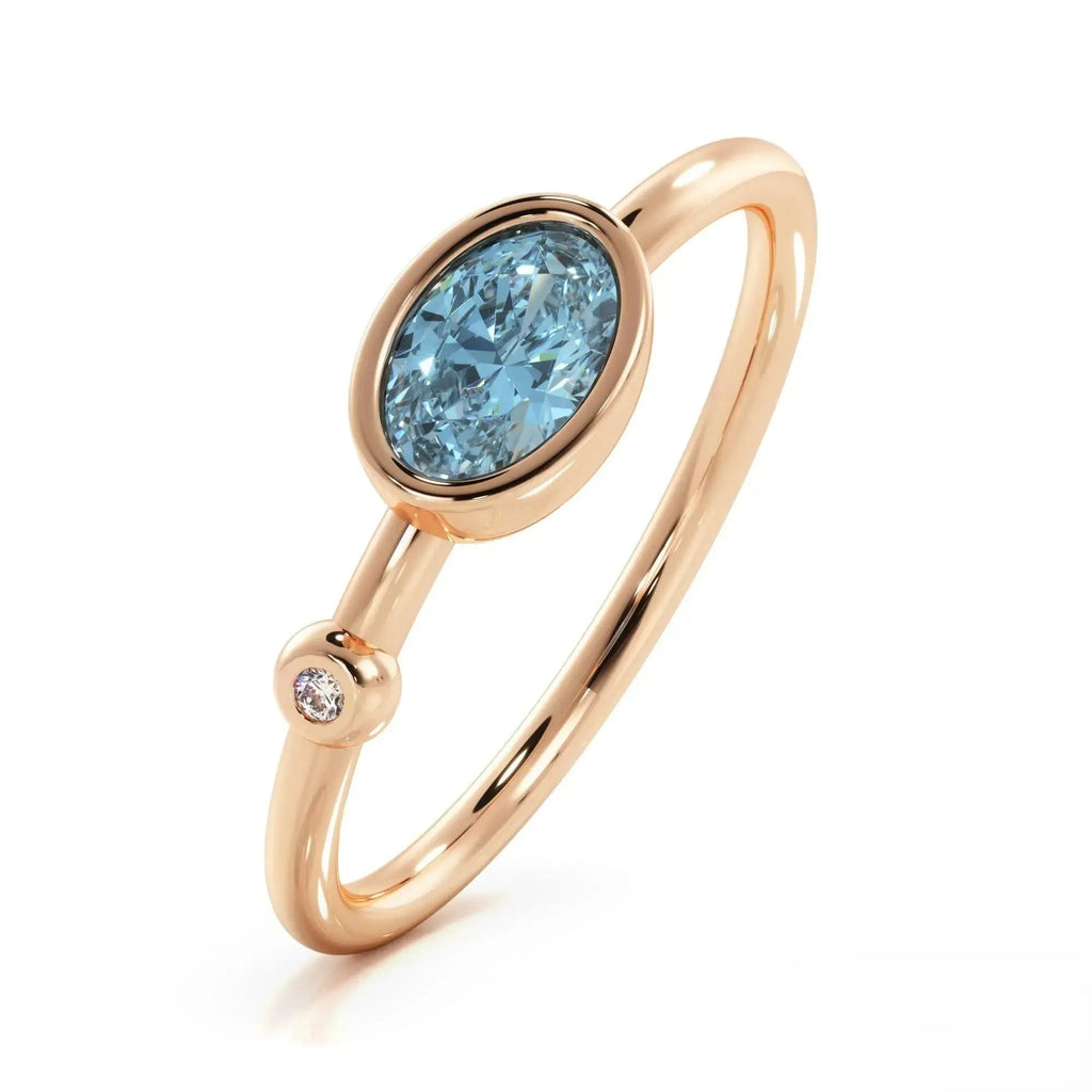 Rose gold ring with oval London Blue Topaz and diamond accent in gemstone ring design