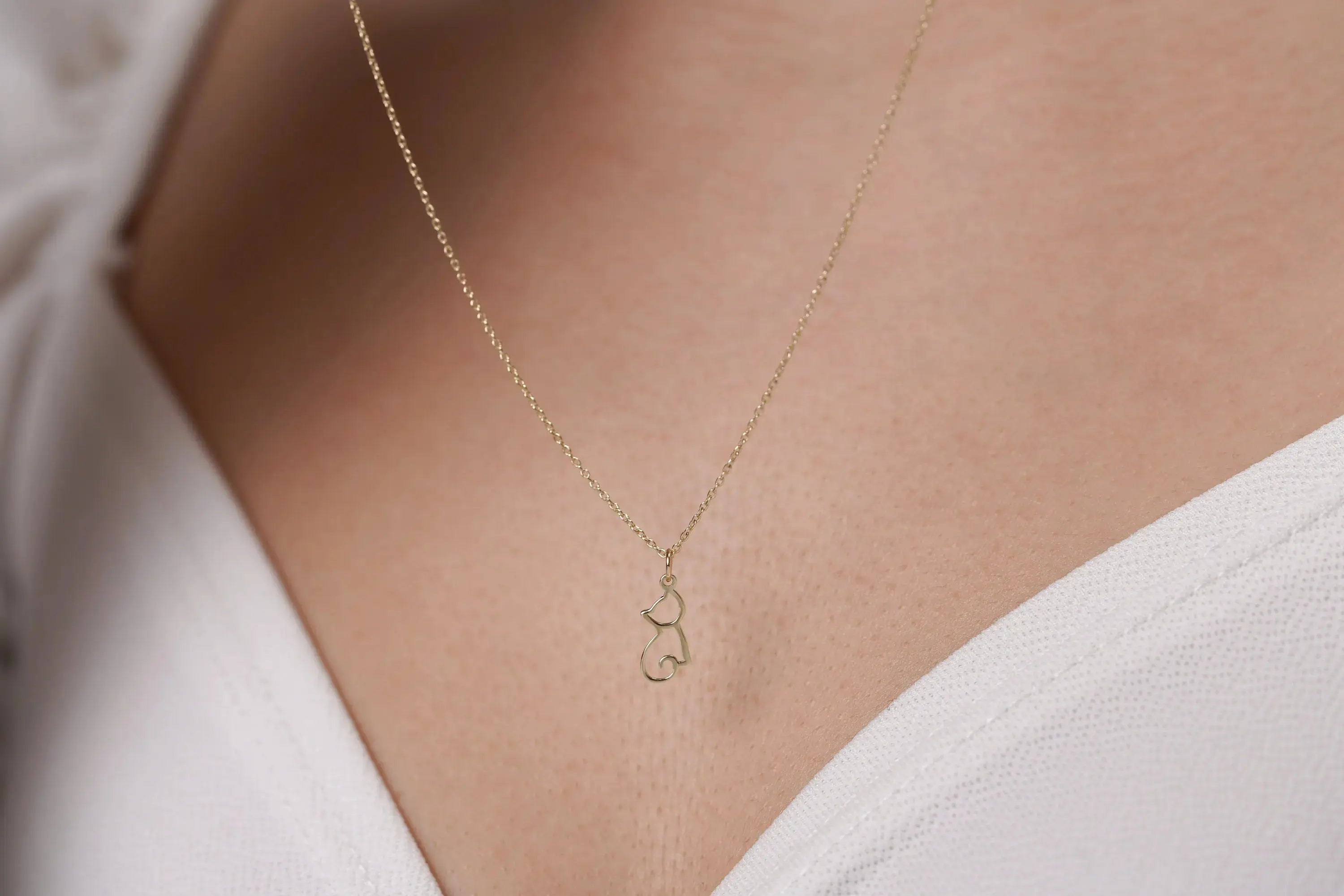 Delicate 14K Solid Gold Cat Pendant featuring a stylish curved design for cat lovers