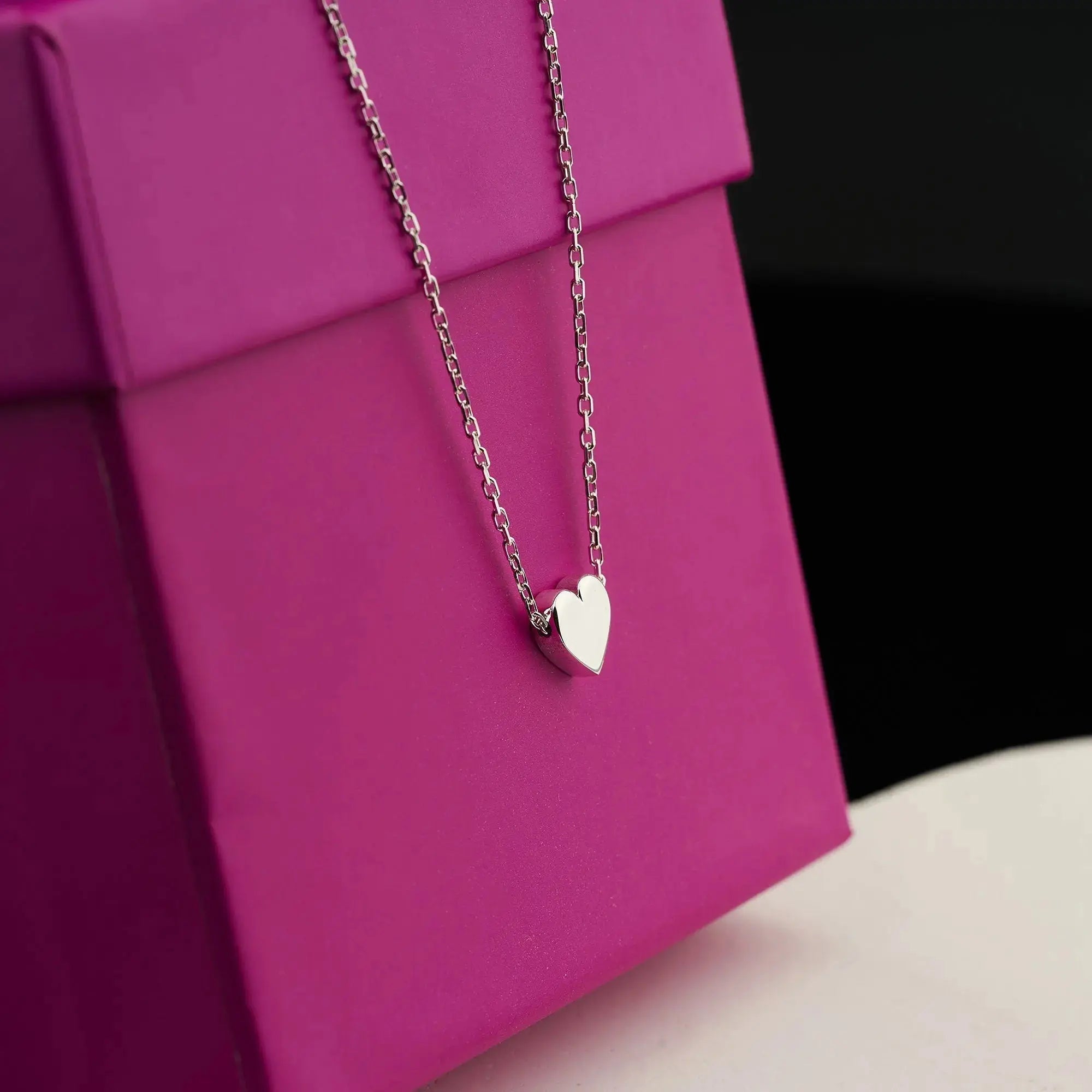 Delicate silver heart pendant necklace on thin chain, perfect for a gold heart jewelry collection