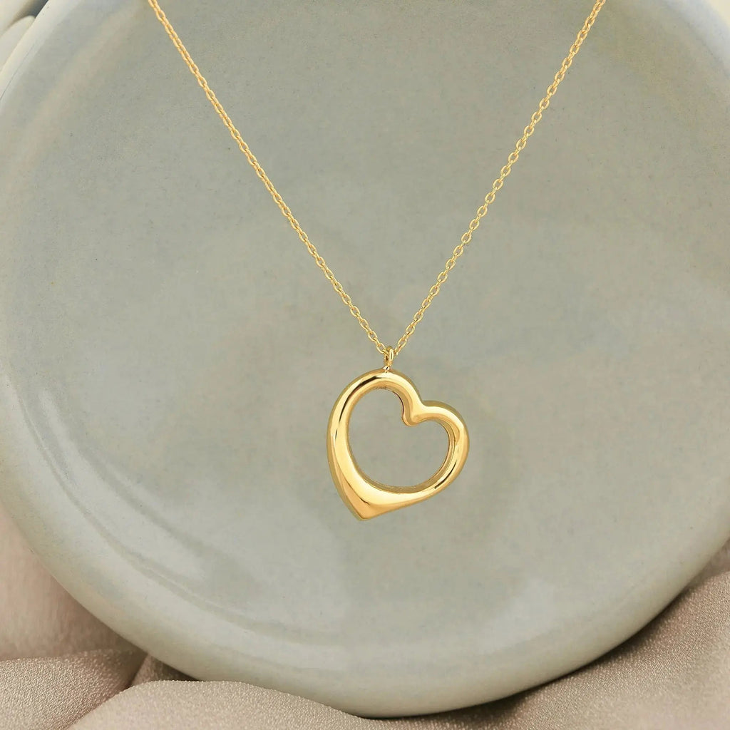 Gold heart-shaped pendant on delicate chain necklace in 14K solid gold, elegant gift for her