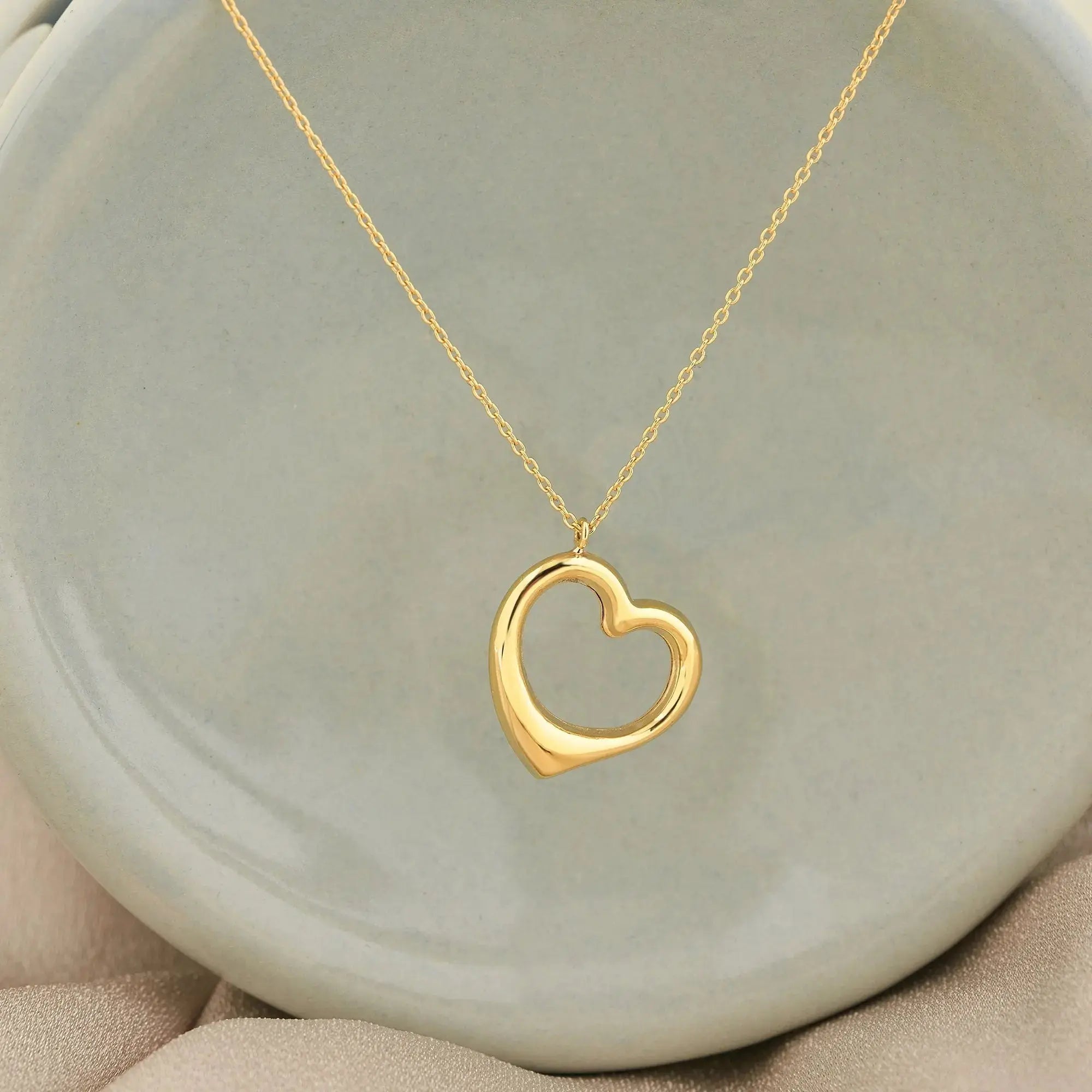 Gold heart-shaped pendant on delicate chain necklace in 14K solid gold, elegant gift for her