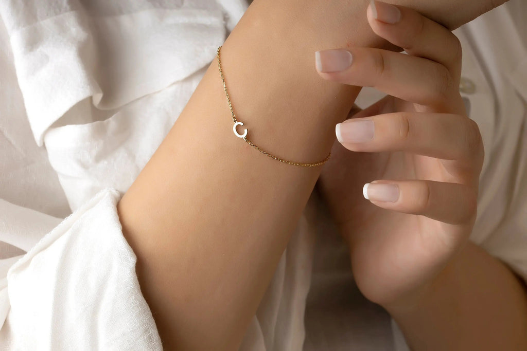 Delicate 14K Solid Gold Initial Bracelet with heart charm elegantly worn on wrist