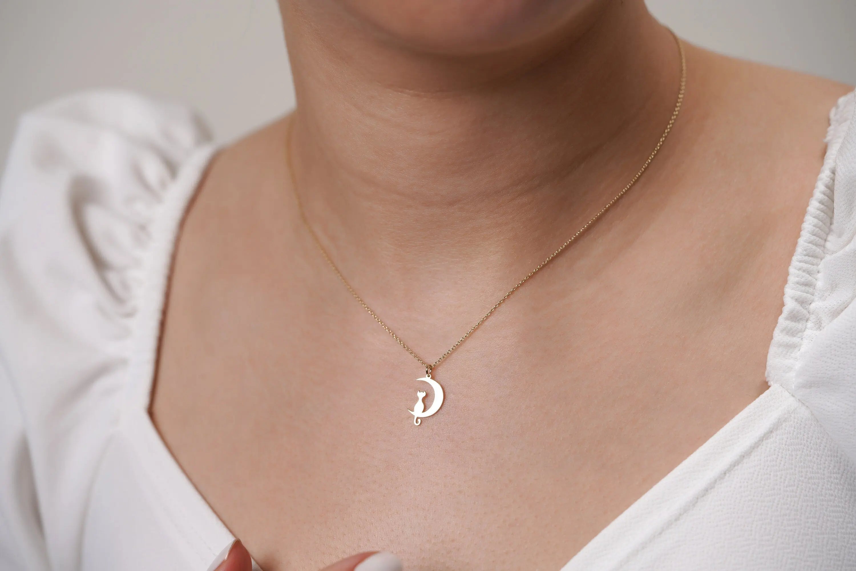 Delicate crescent moon necklace in 14K solid gold on a thin chain for cat lovers