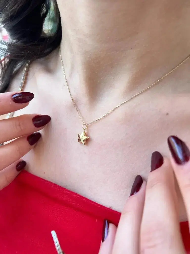 Delicate gold necklace with tiny bee pendant, featuring 14K solid gold star charm