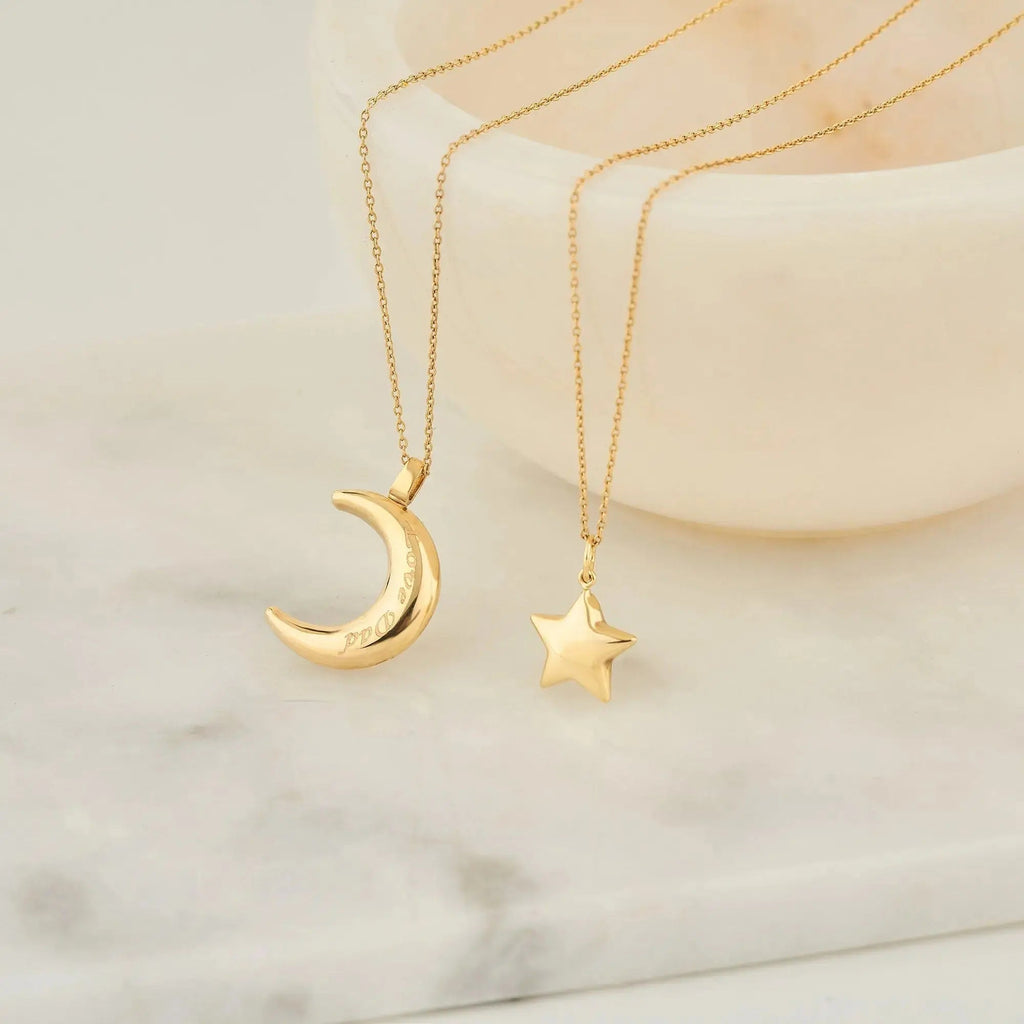 Two gold necklaces with crescent moon and star pendants, featuring 14K solid gold design