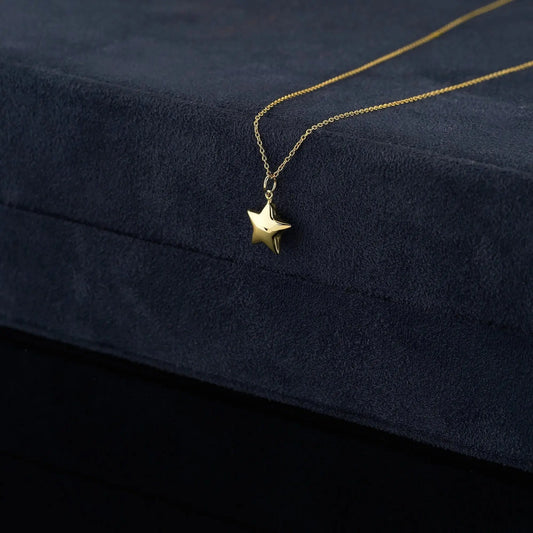 Gold star pendant necklace on a delicate chain in 14K solid gold design