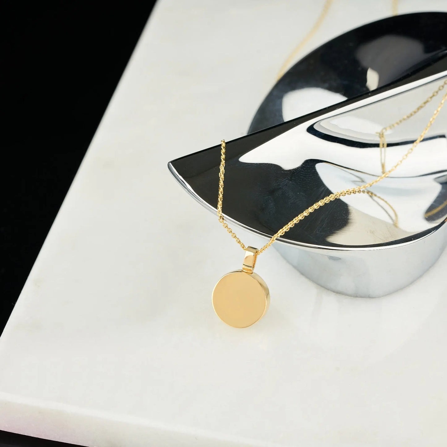 Gold circular pendant on a delicate sterling silver chain necklace with extension chain