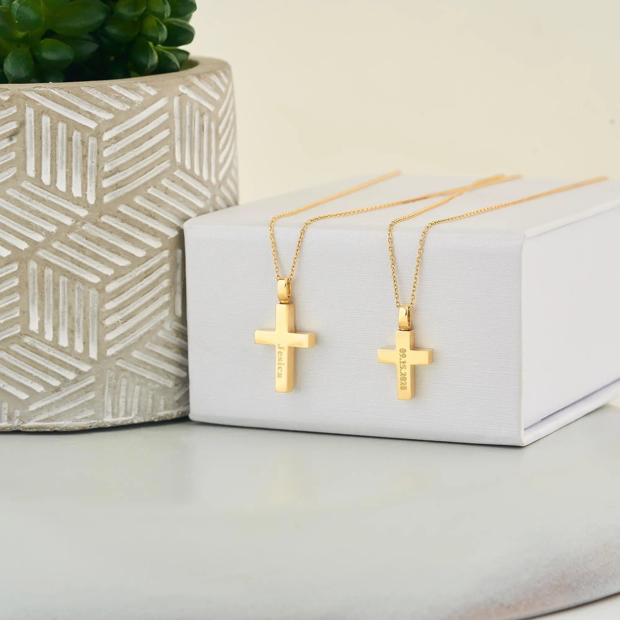 Small and large 14k gold cross pendants shown for size