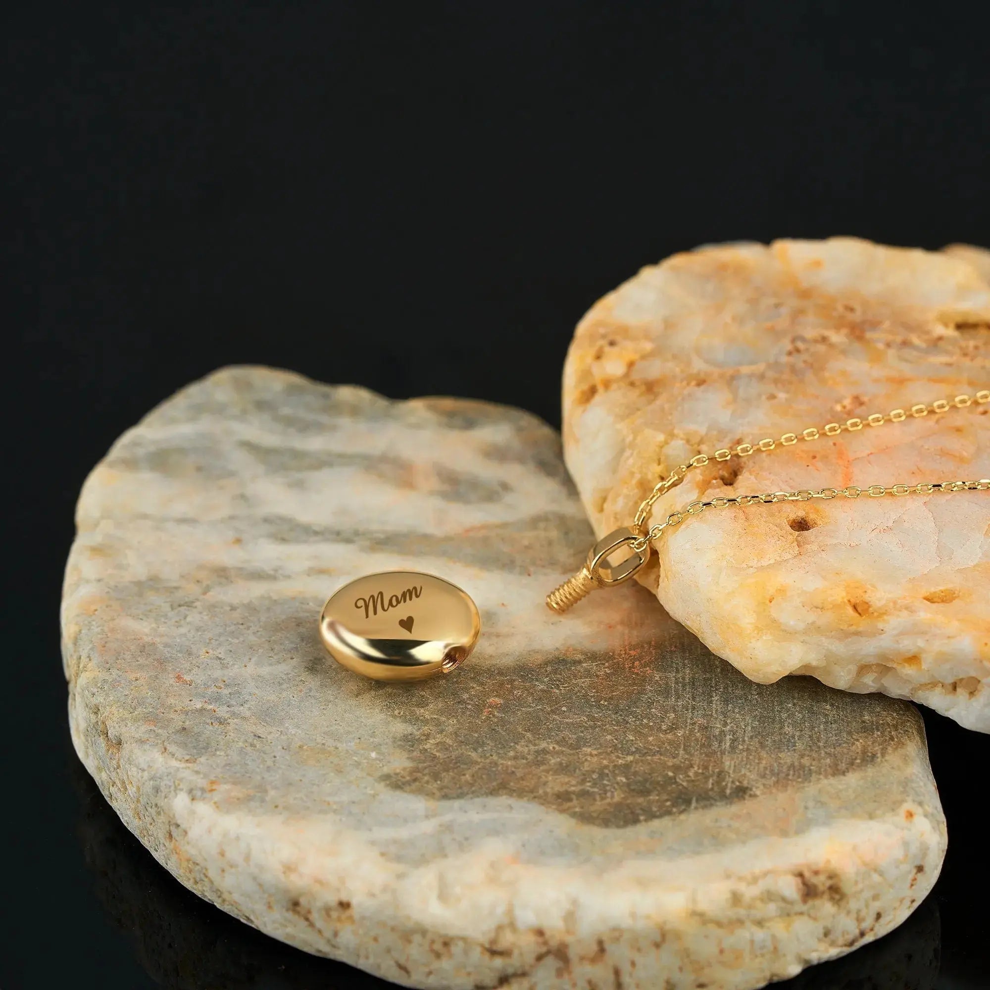 Gold Mom pendant necklace on stone surface, part of Ash Holder Round Urn collection