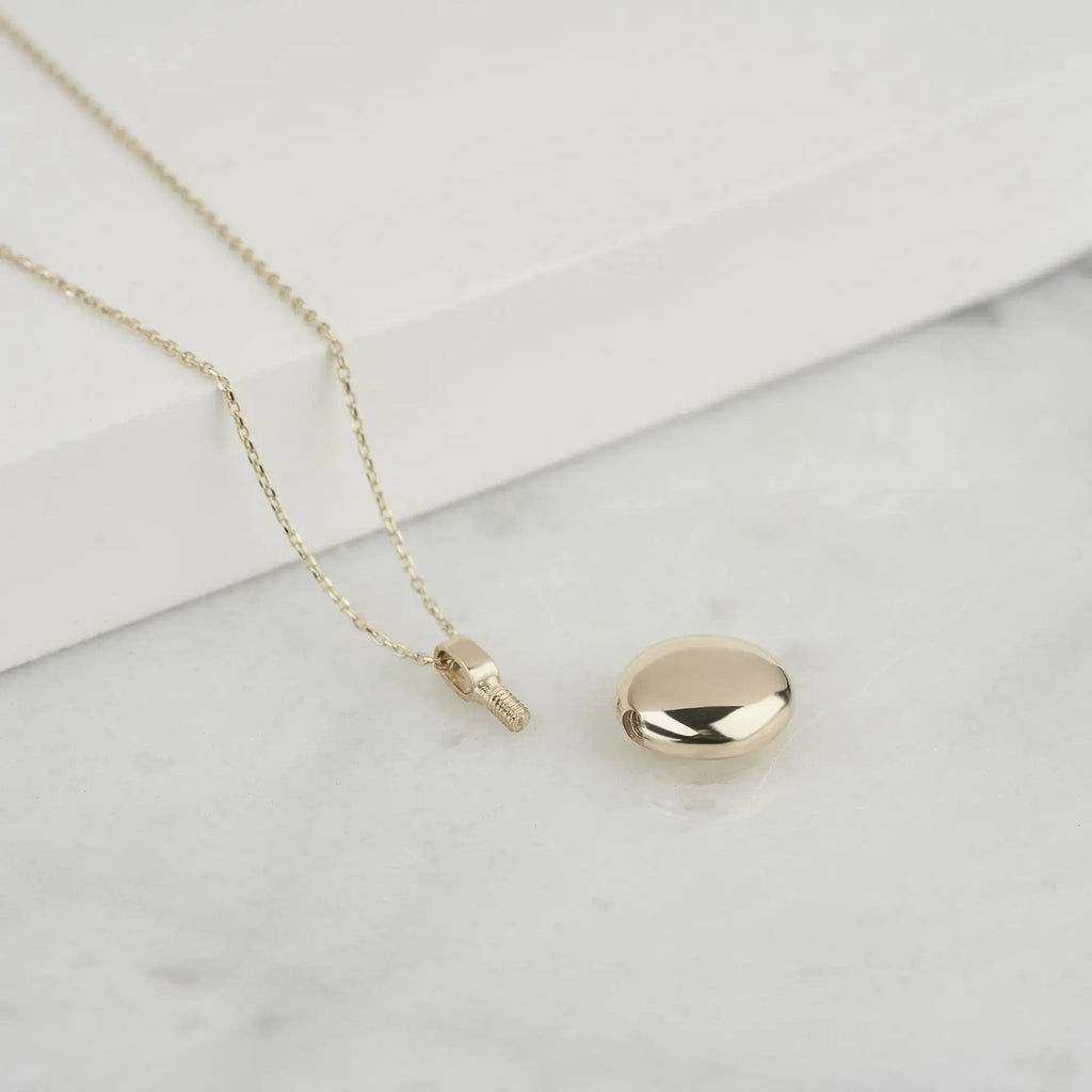 Gold oval locket pendant on a delicate chain for Ash Holder Round Urn Necklace