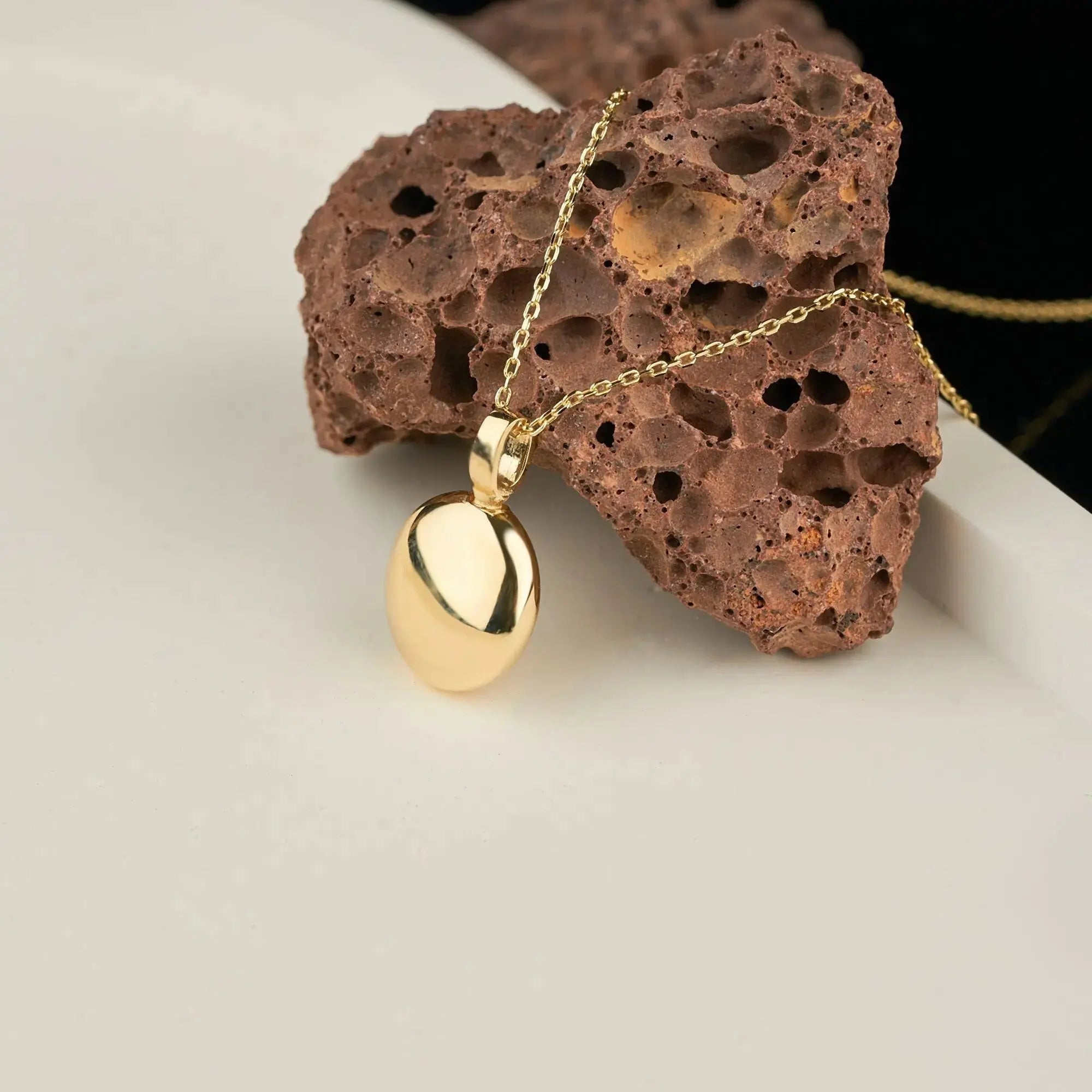 Gold pendant necklace with teardrop charm, part of Ash Holder Round Urn design