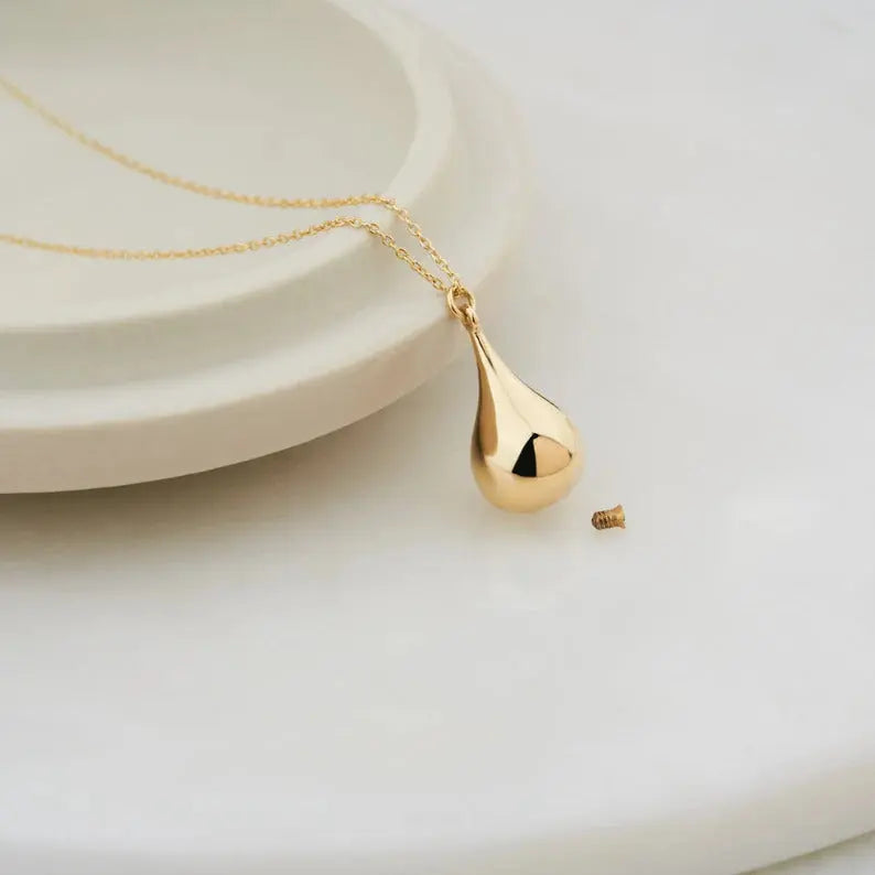 Gold tear drop pendant on a delicate chain of the 14K Gold Tear Drop Urn Necklace