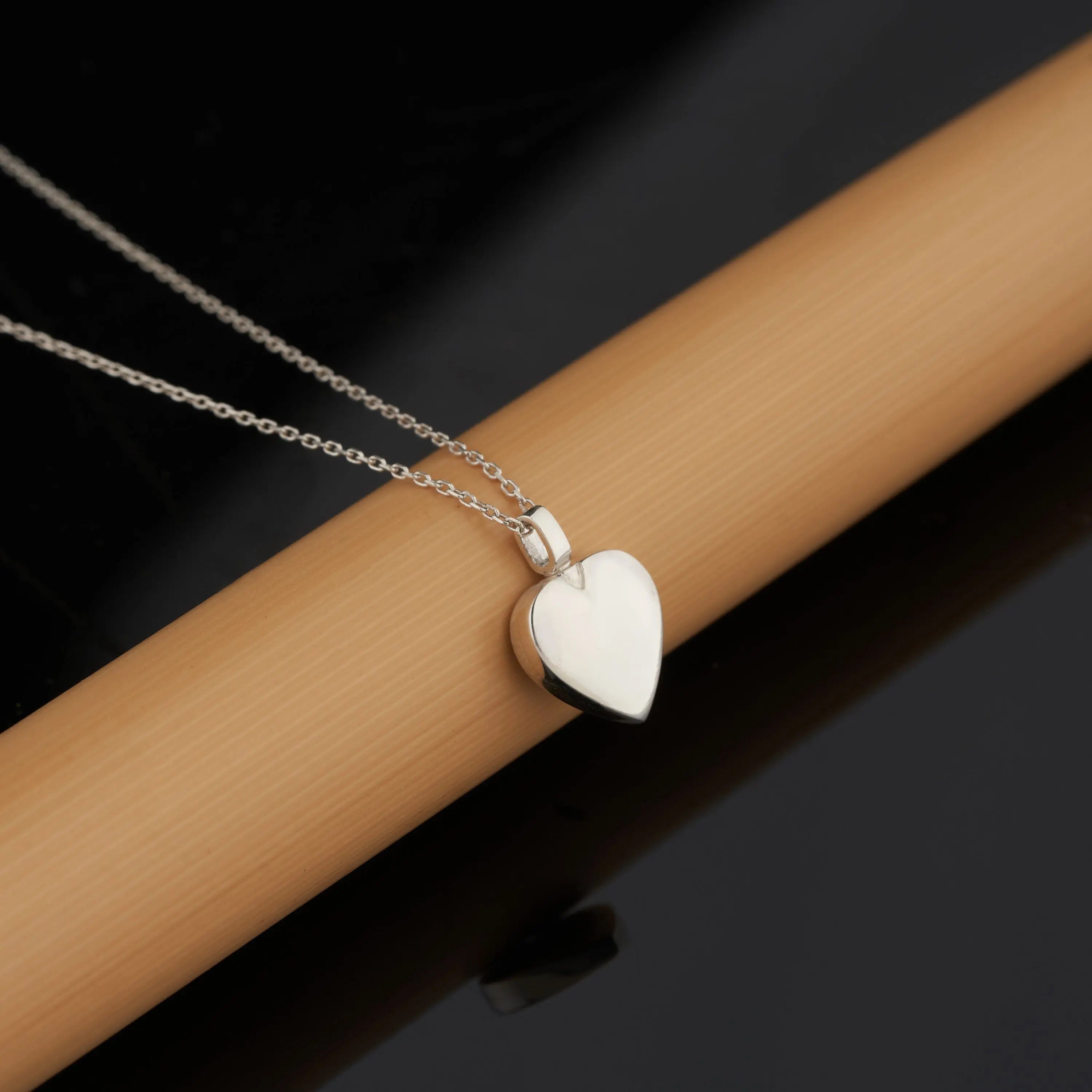 Silver heart-shaped pendant necklace with white pearlescent finish in solid gold design