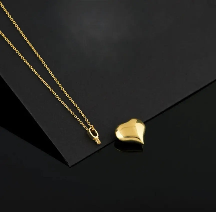 Gold heart pendant on delicate chain, ideal for cremation jewelry and urn necklace purposes