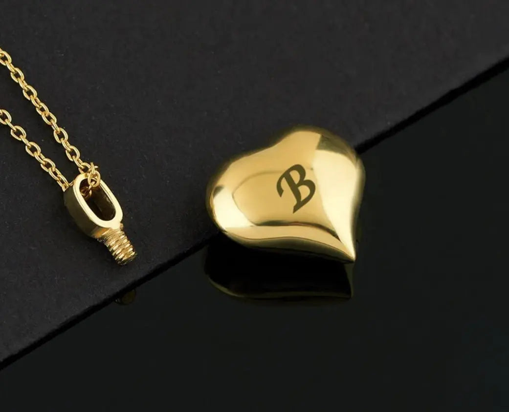 Gold heart urn pendant engraved with B, part of cremation jewelry necklace collection