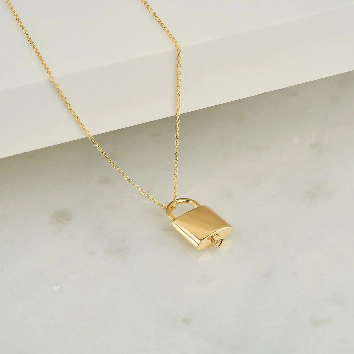 Gold padlock urn pendant on a delicate chain necklace for memorial ash keepsakes
