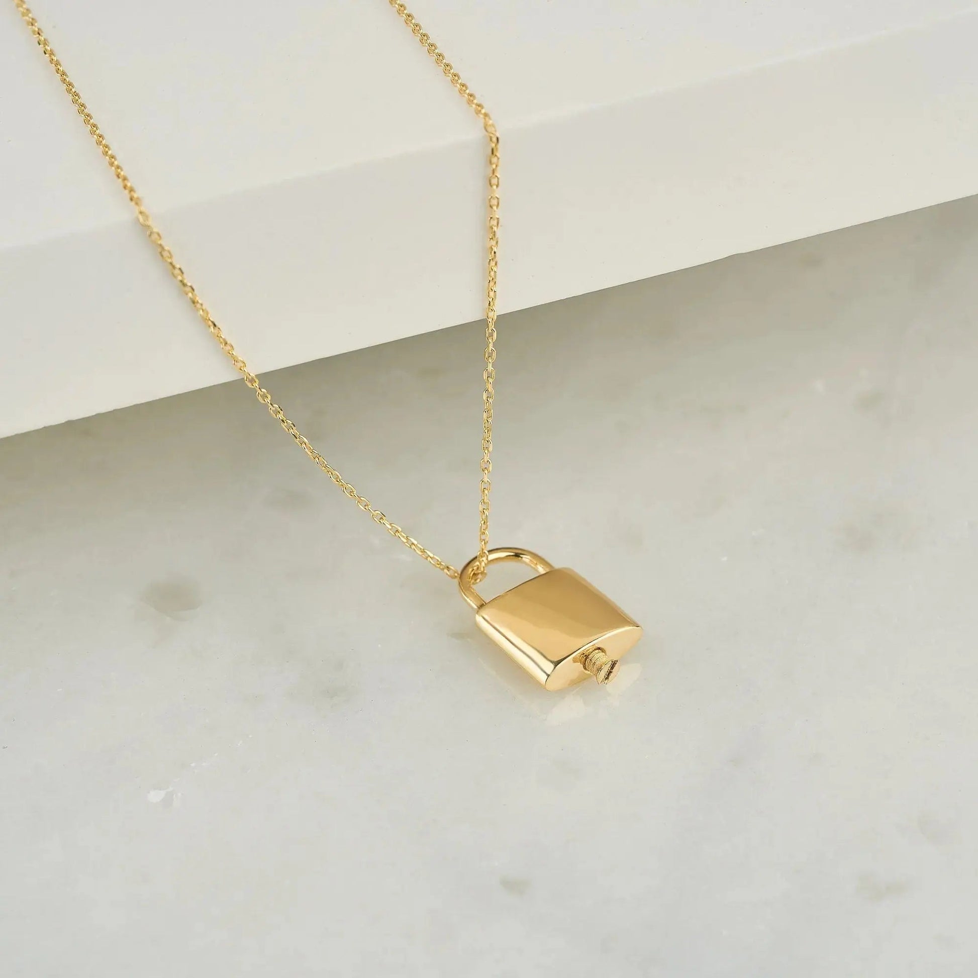 Gold padlock urn pendant on a delicate chain necklace for memorial ash keepsakes