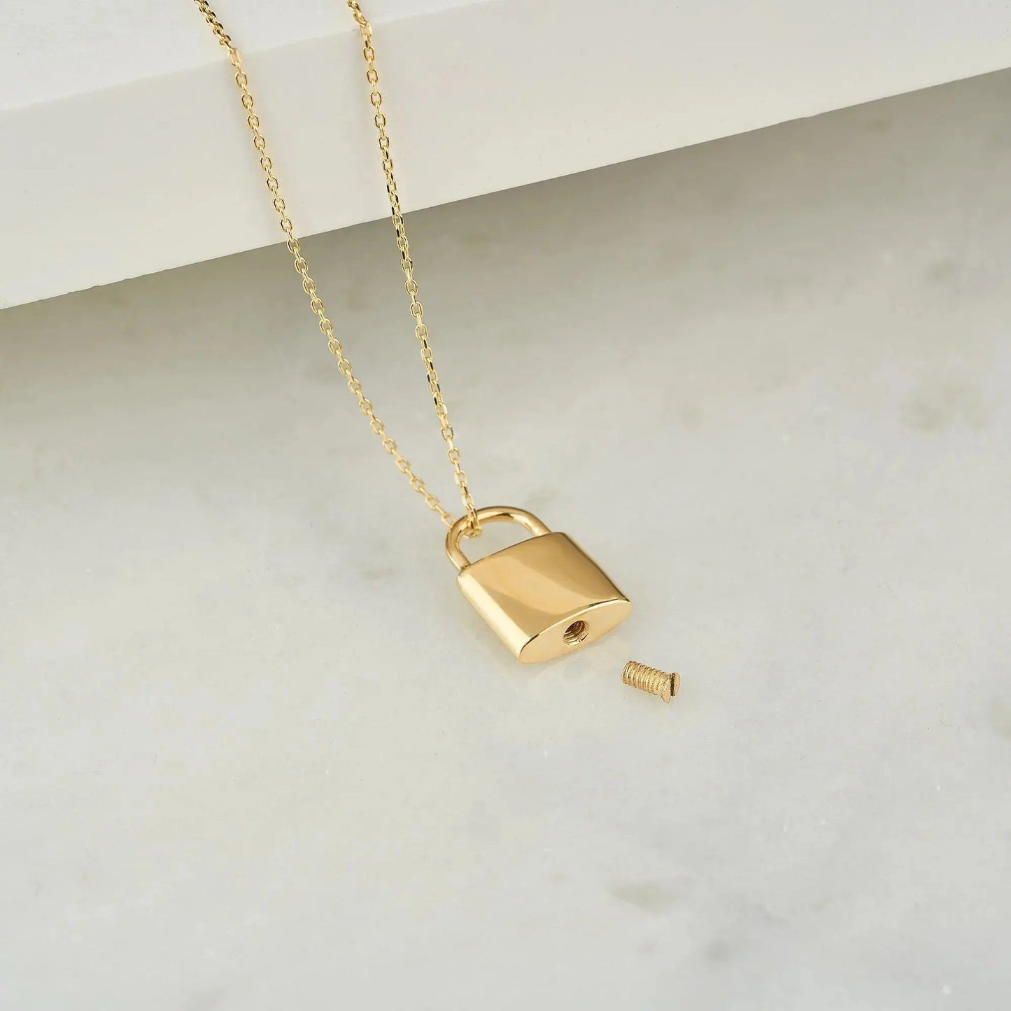 Gold padlock urn necklace with detachable key on delicate chain for memorial keepsakes