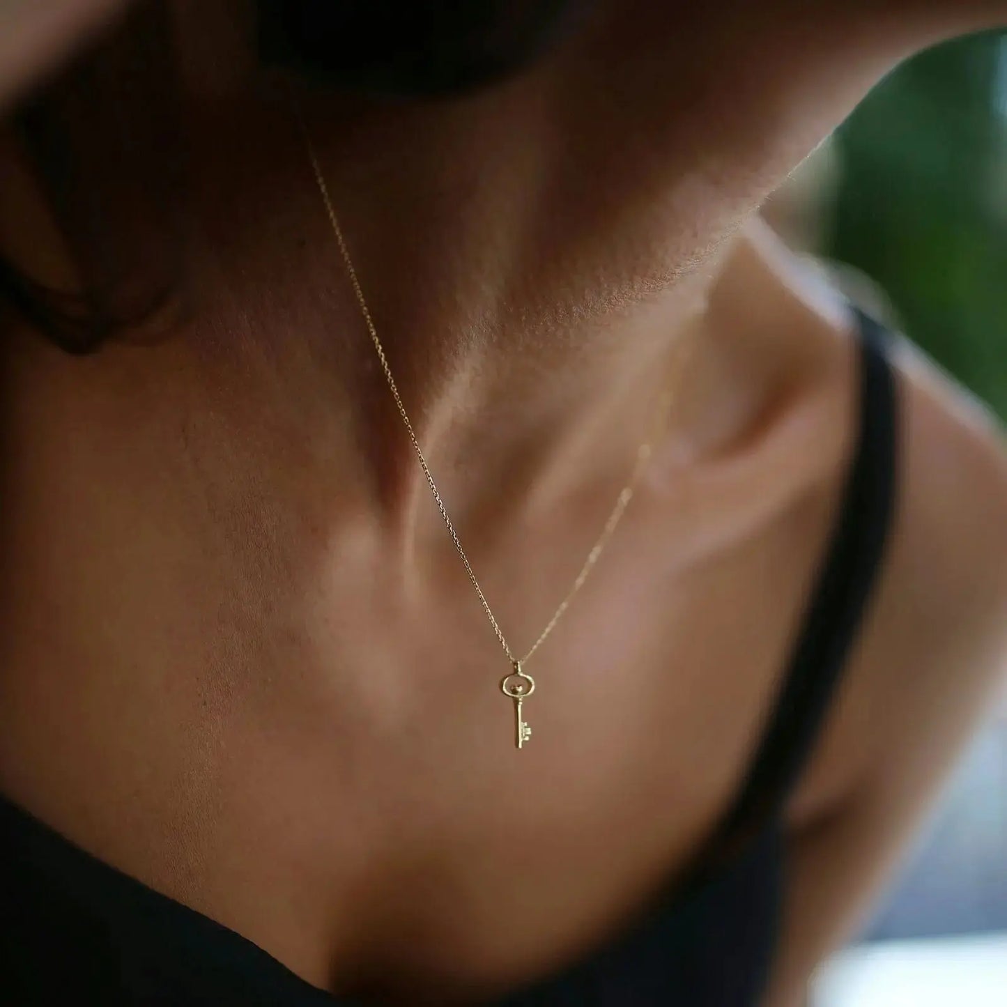 Delicate key necklace 14K solid gold featuring a dainty gold key pendant on a thin chain
