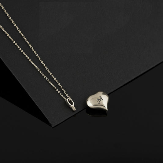 Silver heart-shaped pendant with engraved initial on a delicate chain, suitable for Dad Mom